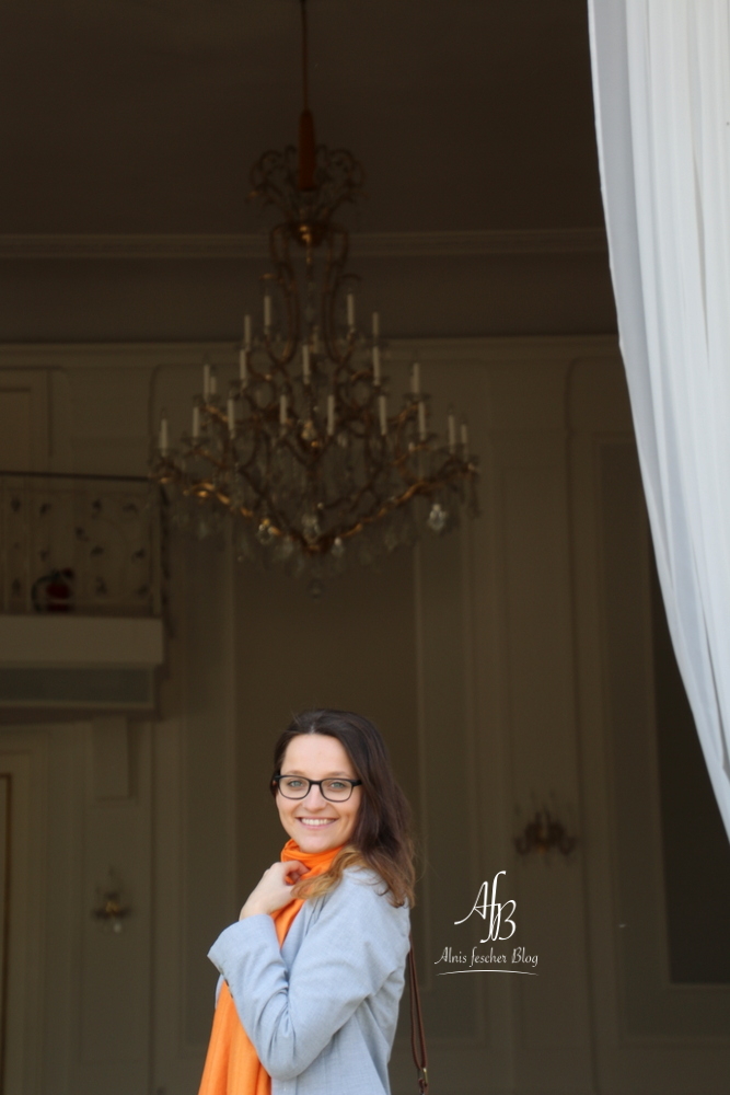 Casual grey meets orange scarf in Vienna